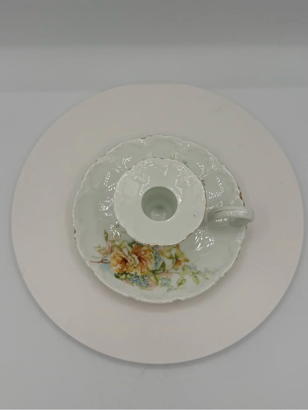 Vintage porcelain taper candle stick holder with floral motif and gold edging
